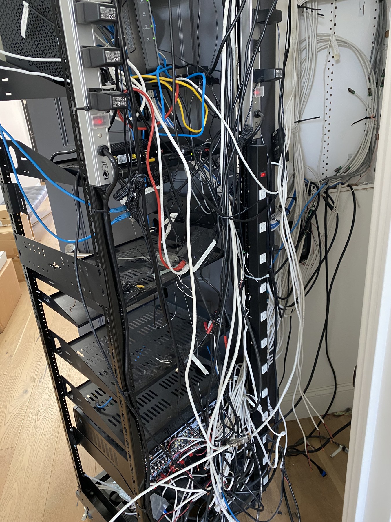 Original Beverly Grove rack before Southland’s work, with tangled cables, loose connections, and disorganized equipment