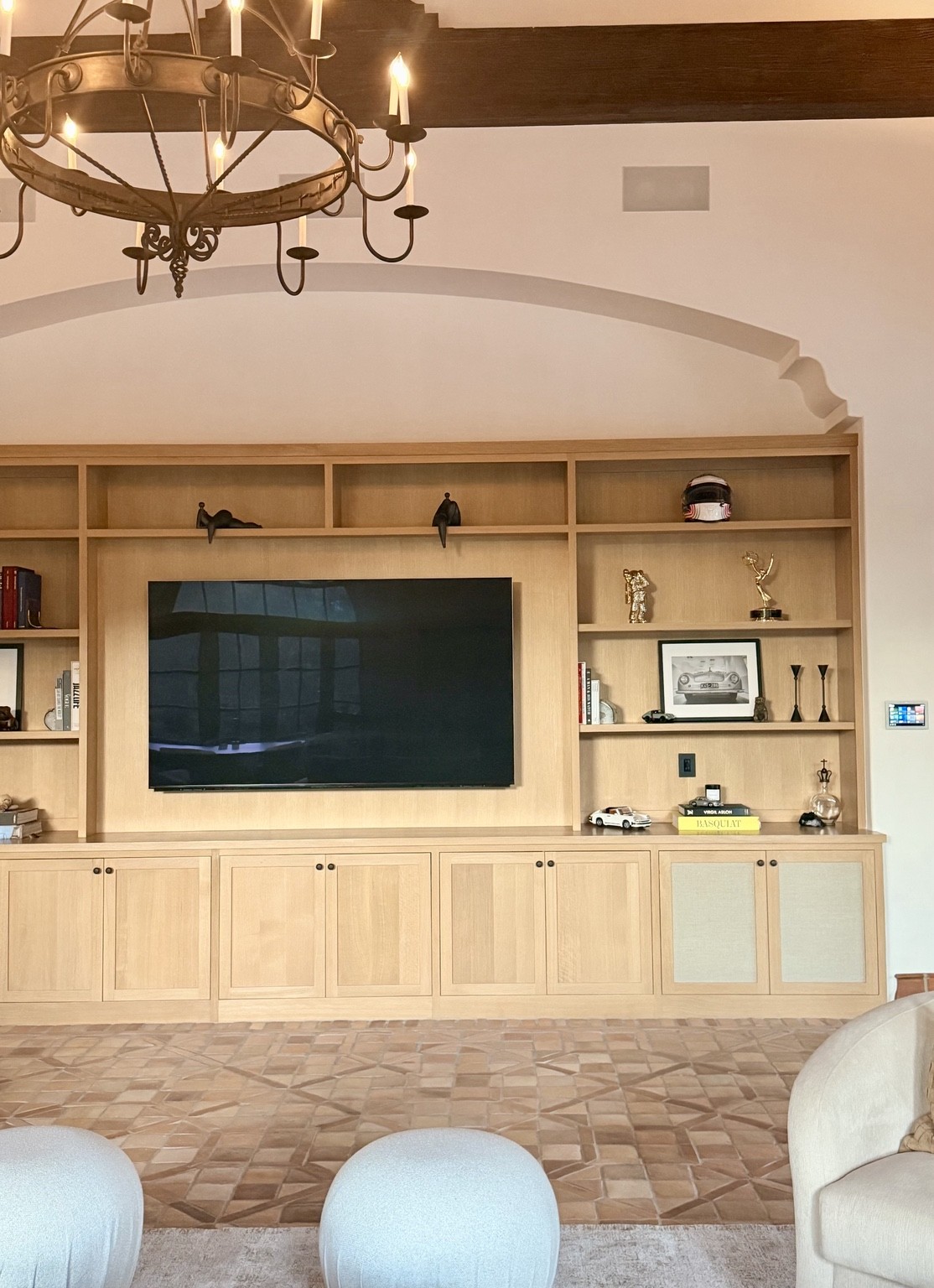 Closer view of the living-room display integrated into cabinetry with a nearby wall control