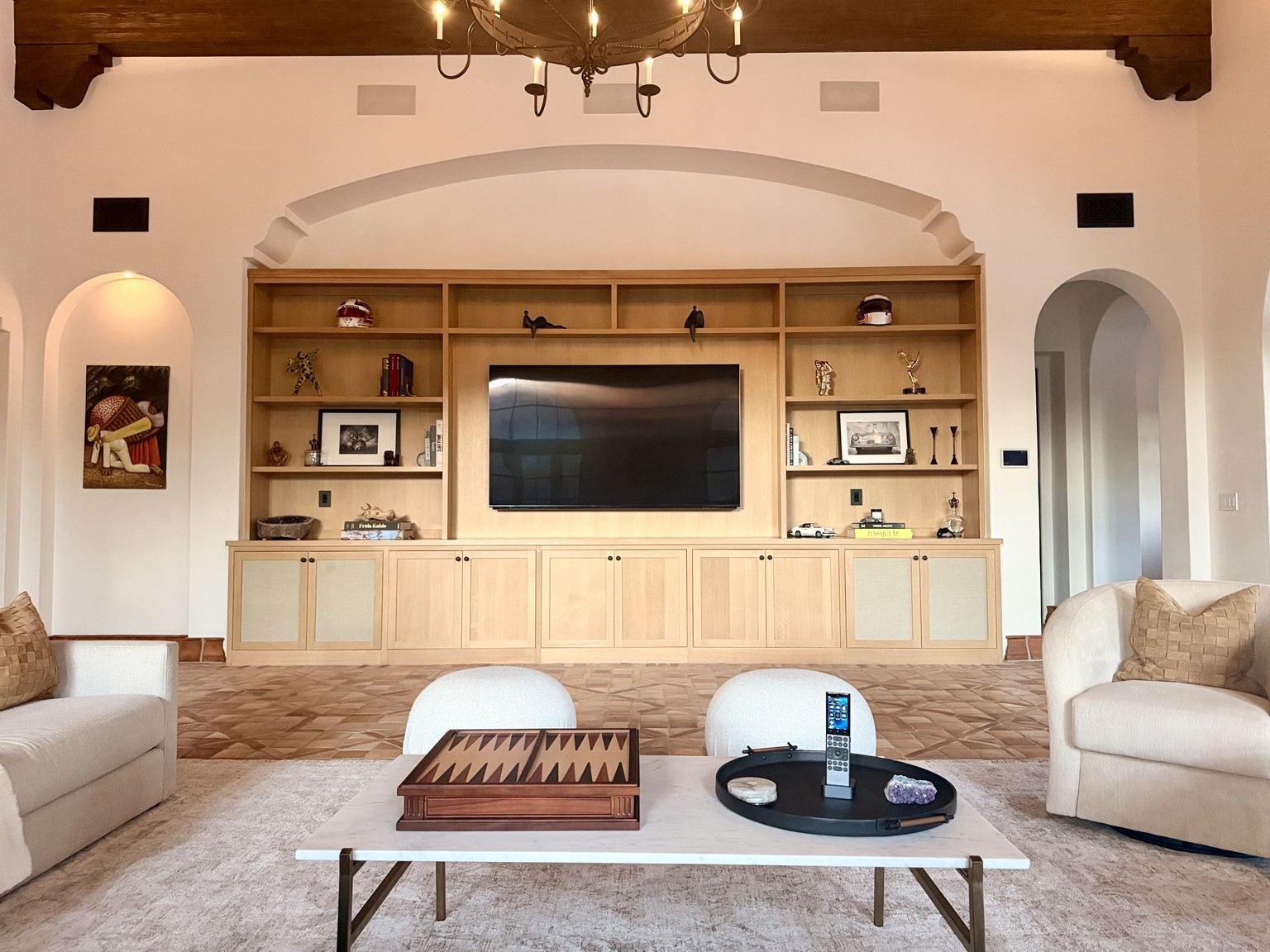 Lakeview Canyon living room with a television integrated into custom cabinetry, built-in speakers, a wall touchscreen, and a handheld remote