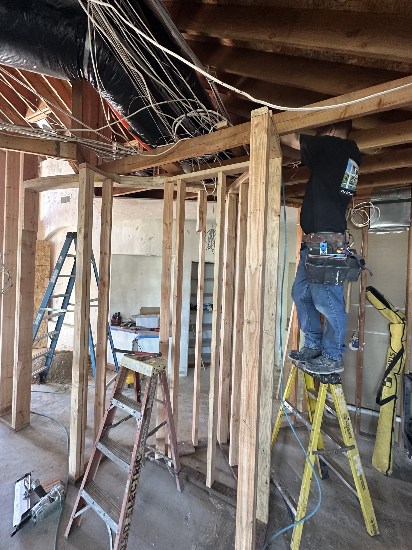 Installer working on wiring in open framing during the remodel